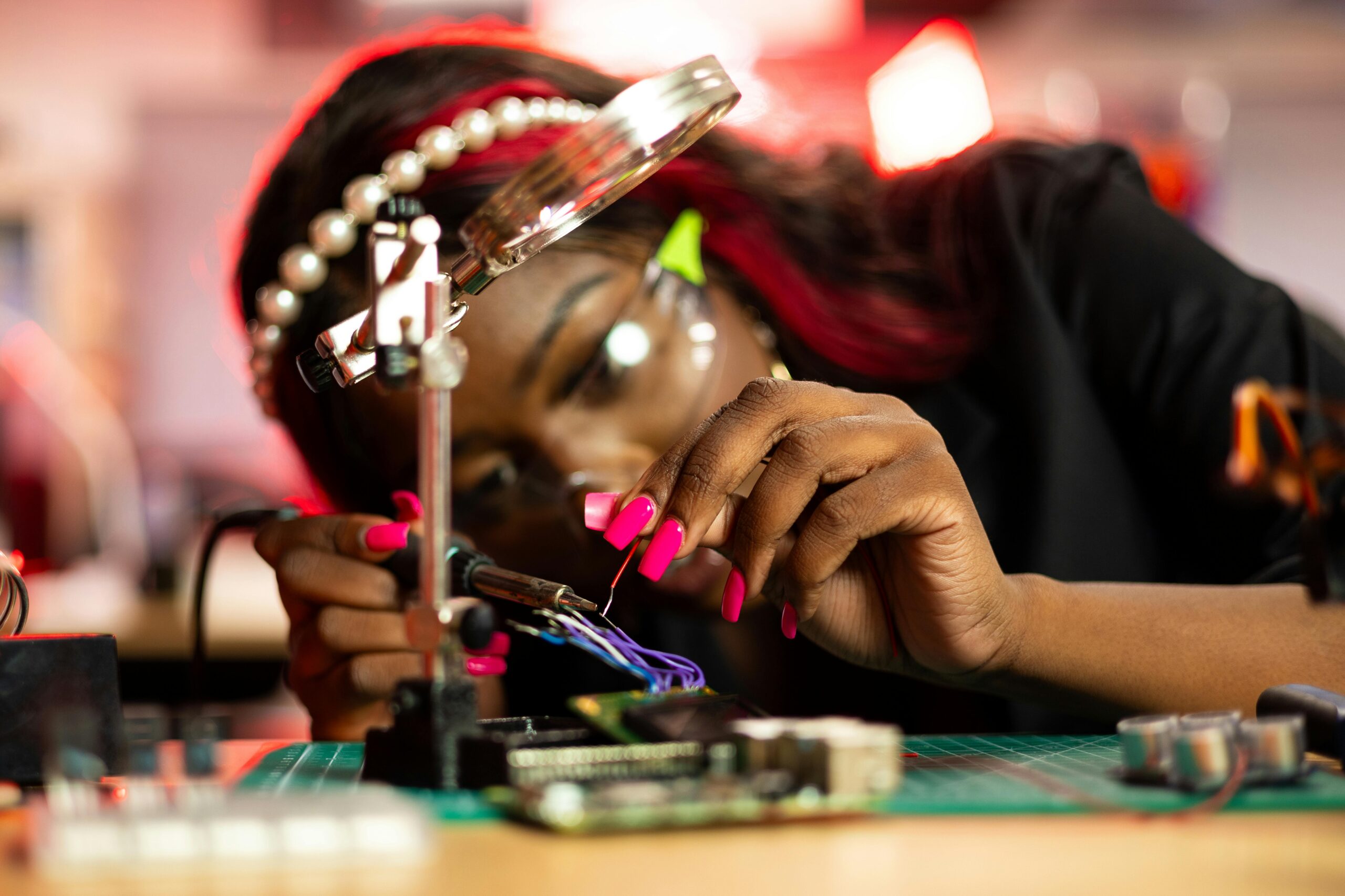 A woman of color assembling a micro computer